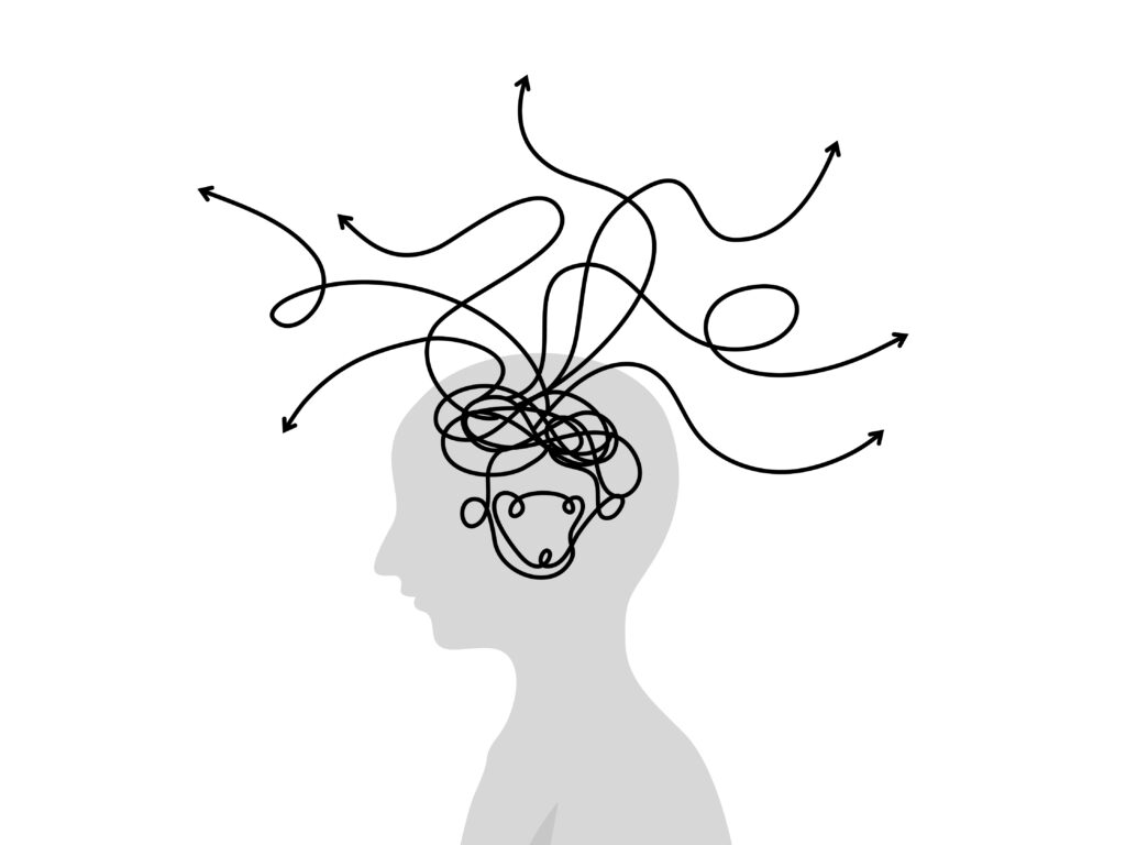Image is of a head and wiggly lines as thoughts to depict being side tracked easily as an individual with ADHD. This blog article looks at some examples of adult behaviours in individuals with ADHD, written by neuro affirming counsellor and psychotherapist Amanda Reynolds. 